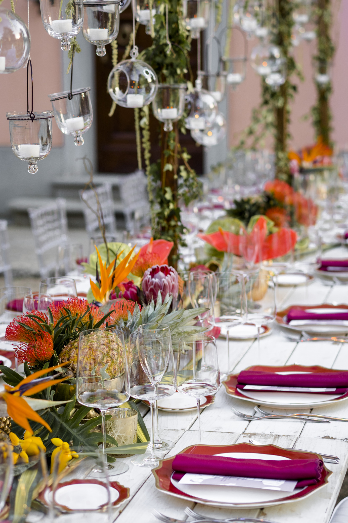 Tropical themed birthday dinner with colored flowers and table setting