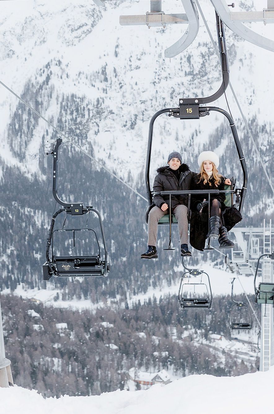 Bride and Groom on a chair lift for a luxury welcome party in Sankt Moritz