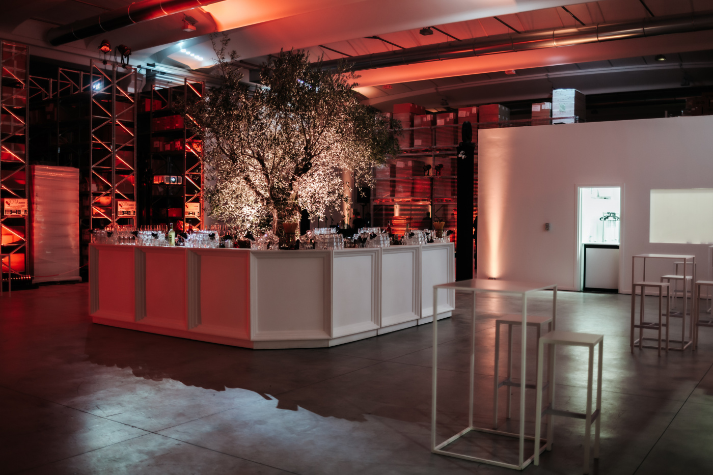 Event entrance with white bar station and olive tree