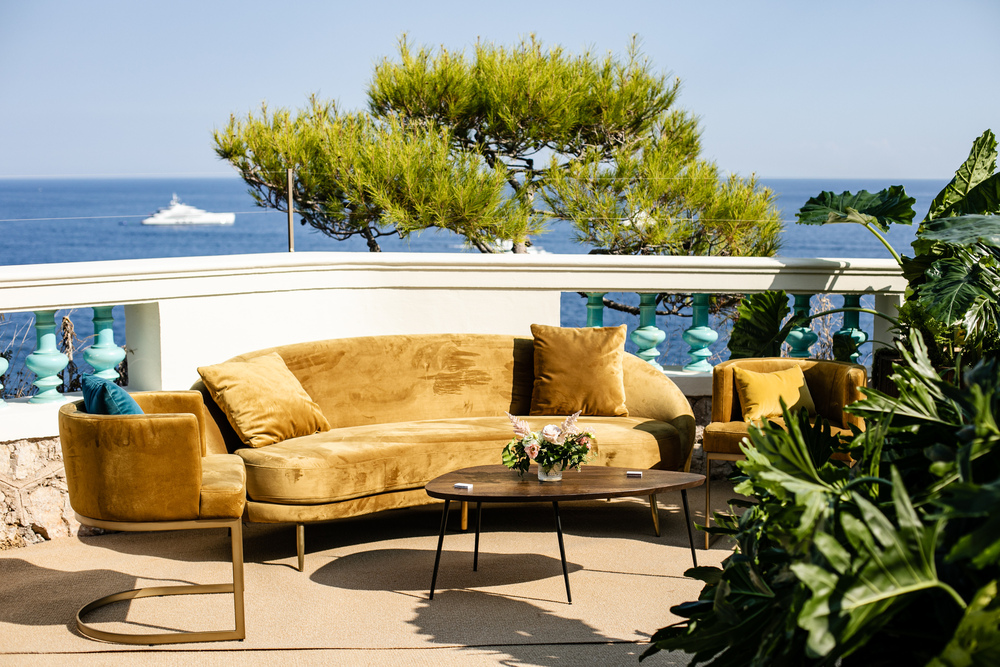 Gold sofa during cocktail hour at luxury Belle Epoque La Vigie wedding villa on the French Riviera