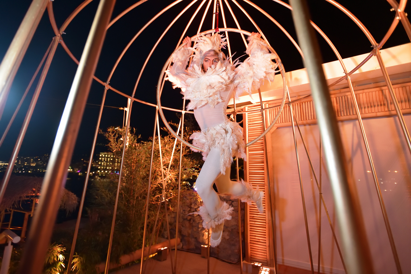 acrobat dancing in a golden cage as birthday entertainment