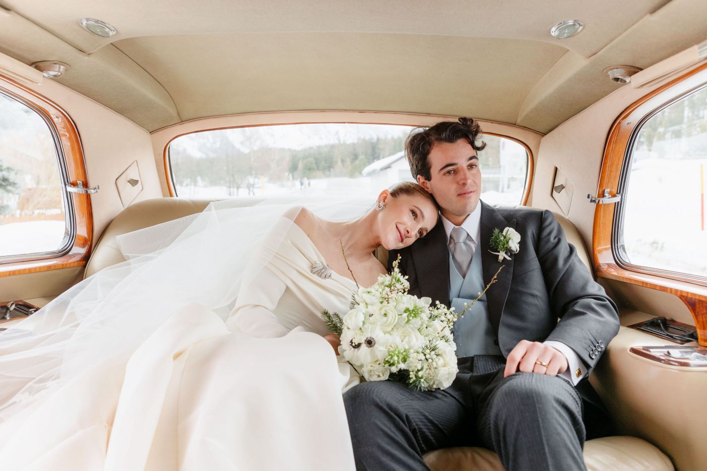 romantic bride and groom in a car for a luxury ceremony in Sankt Moritz