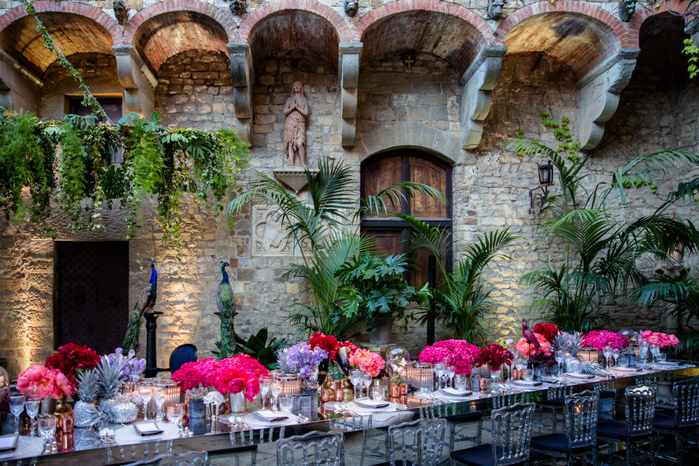 Long rectangular table with plants and flowers with red and fuxia