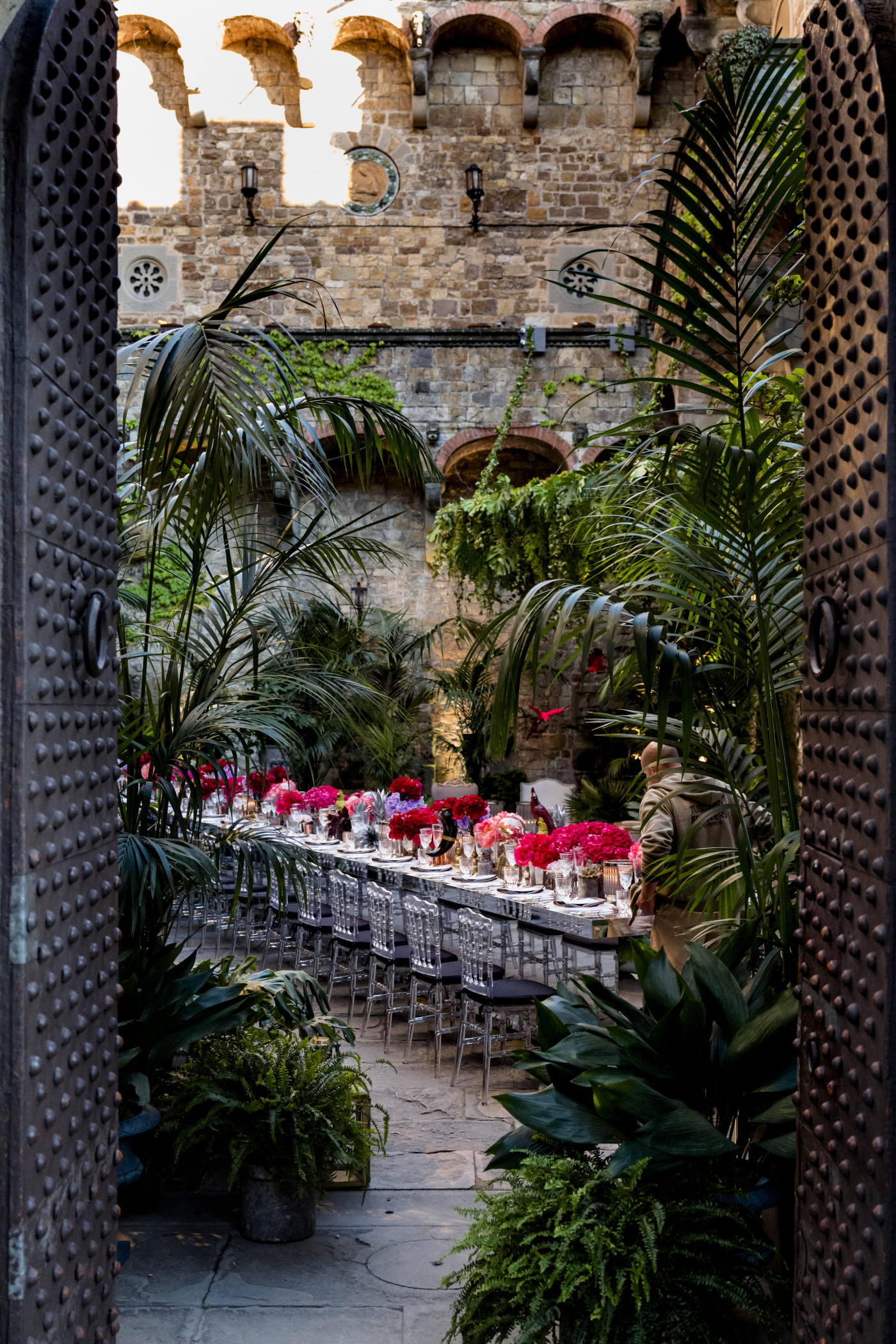 Castle courtyard decorated with plants and hanging greenery for a jungle effect