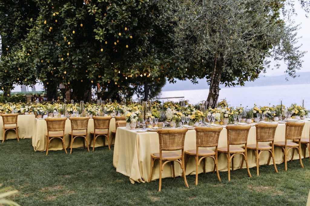 Long tables under the magnolia with hanging lemons on Lake Garda