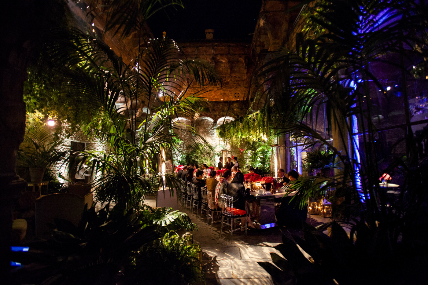 Castle courtyard for wedding dinner with fuxia flowers