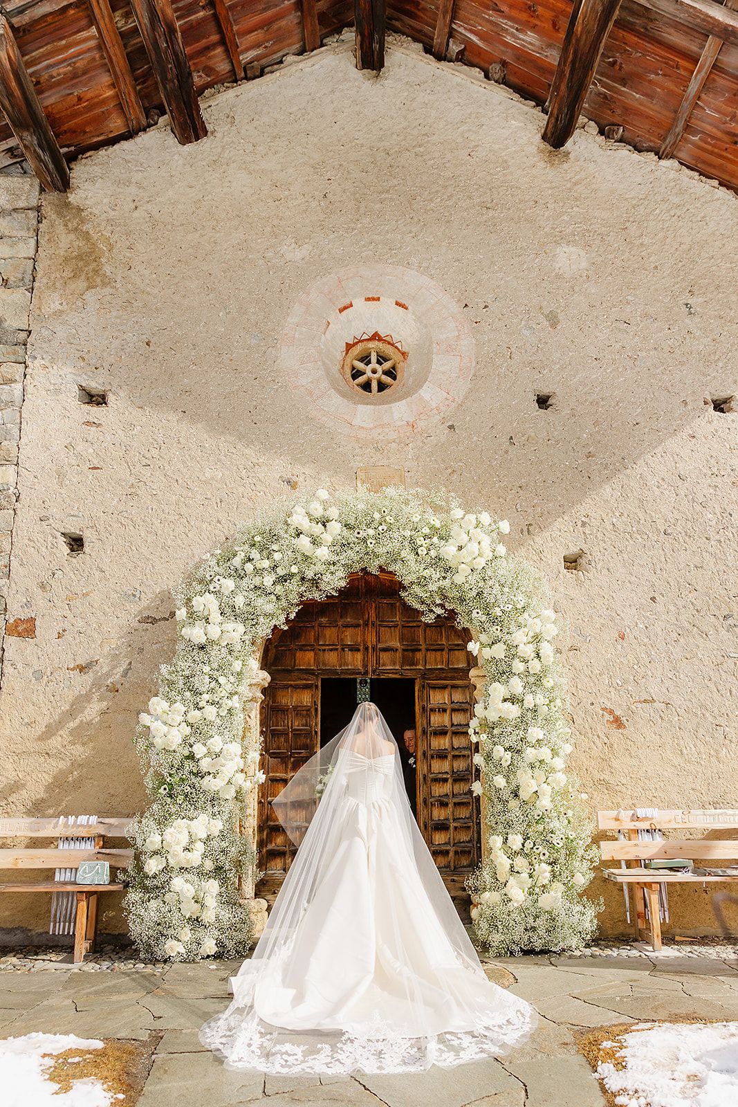 Flowers arch in a church in Sankt Moritz for a luxury winter wedding