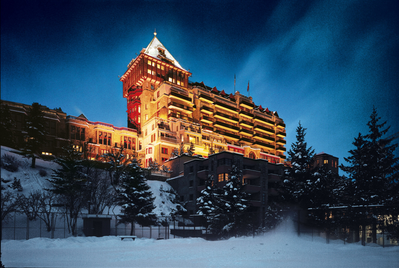 Night view under the snow of historic luxury wedding palace in Saint Moritz